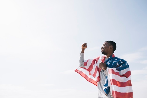 african american man wrapped usa flag 23 2148165999